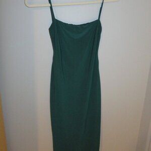 Sleeveless, backless, emerald green dress with tight fit